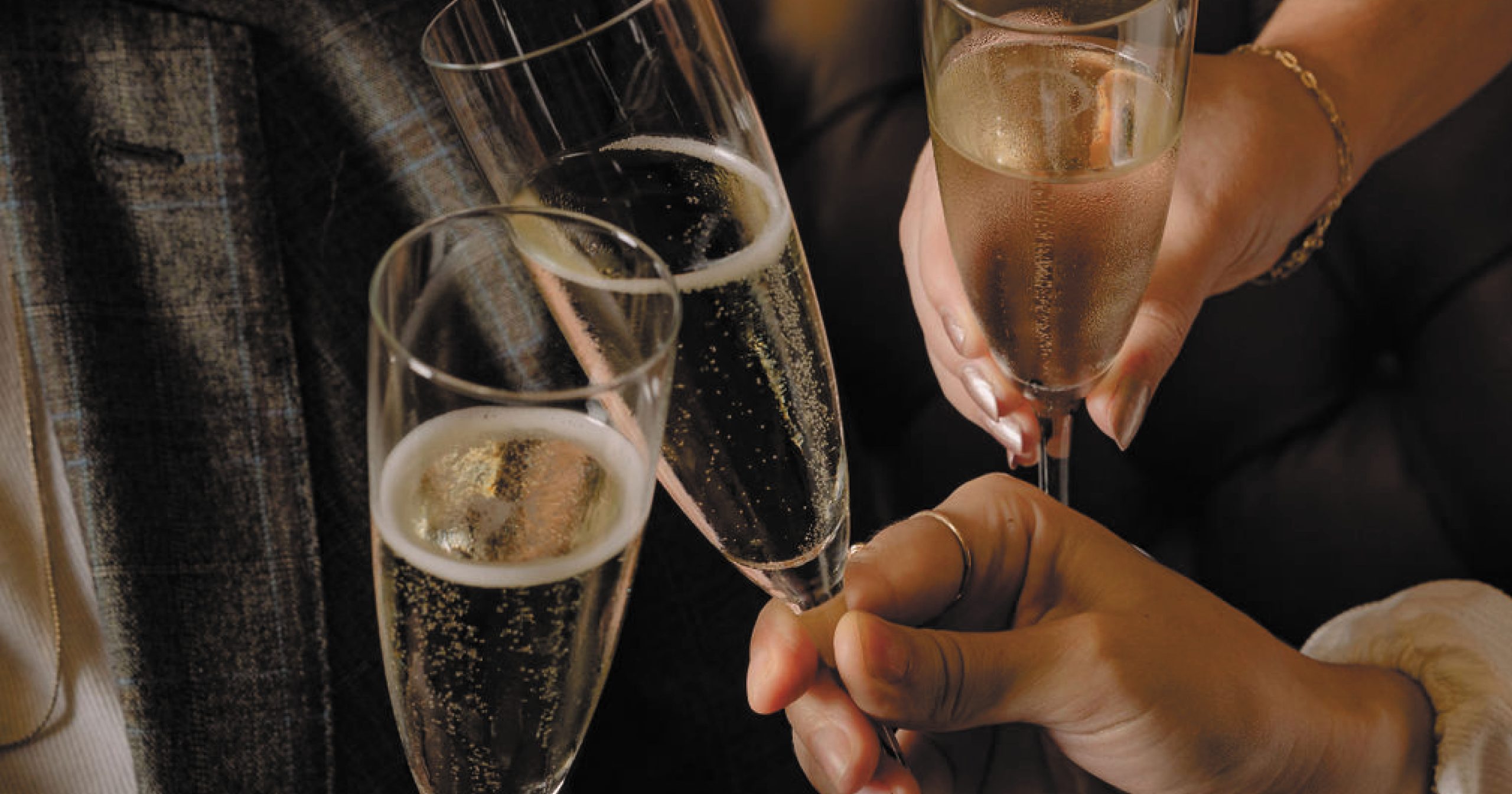 Three champagne glasses clinking