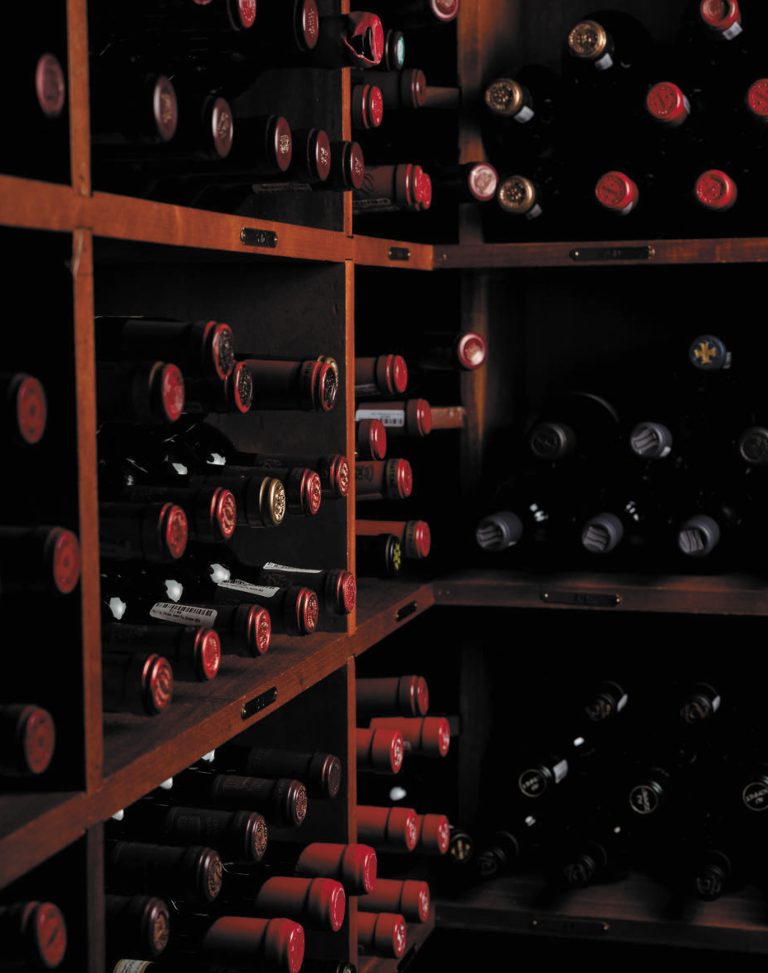 Wine storage shelves full of red wine bottles