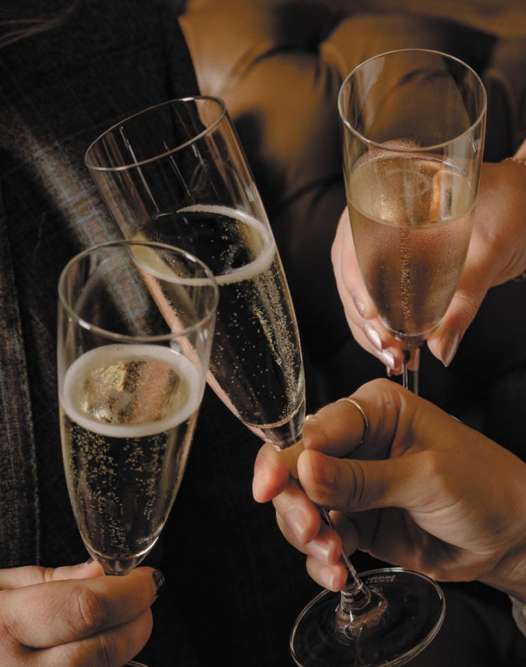 Three champagne glasses clinking